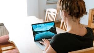 Woman sitting at a table on her laptop